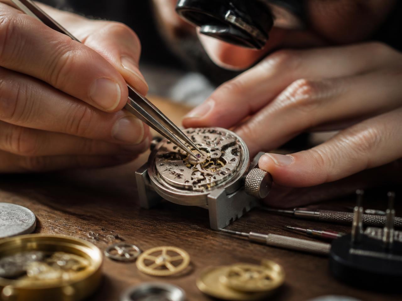 A watchmaker repairing a mechanical watch movement